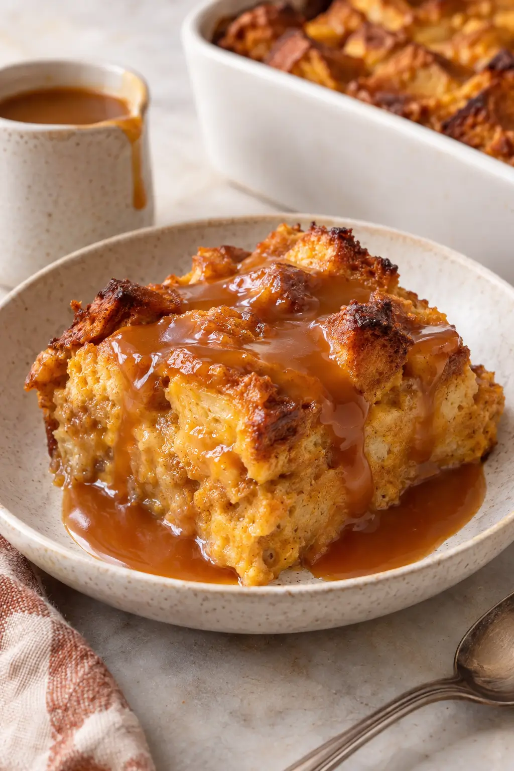 Make-Ahead Pumpkin Bread Pudding with Caramel Sauce served and ready to enjoy